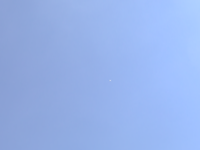 Synthetic EO frame: a small bright target against the sky.